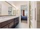 Elegant bathroom with double vanity and a view into the bedroom at 25019 E Alder Dr, Aurora, CO 80016