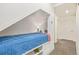 Bedroom featuring a built-in bed with storage underneath and hallway with two doors at 25019 E Alder Dr, Aurora, CO 80016