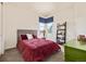 Bright bedroom featuring a comfortable bed, bookshelf and a window letting in natural light at 25019 E Alder Dr, Aurora, CO 80016
