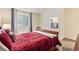 Bedroom with a cozy bed, side table with lamp, curtains on the window, and a closet at 25019 E Alder Dr, Aurora, CO 80016