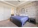 Inviting bedroom featuring a stone accent wall and tray ceiling at 25019 E Alder Dr, Aurora, CO 80016