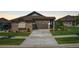 Charming single-story home with a stone facade, well-maintained lawn, and attached two-car garage at 25019 E Alder Dr, Aurora, CO 80016