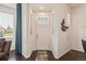 Bright foyer featuring a white door, dark hardwood floors, and natural light from a large window at 25019 E Alder Dr, Aurora, CO 80016