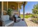 Inviting front porch with seating offering a view of the landscaped yard and neighborhood at 25019 E Alder Dr, Aurora, CO 80016