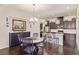 Open kitchen with dark cabinets, stainless steel appliances, and a dining table with seating at 25019 E Alder Dr, Aurora, CO 80016