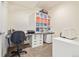 Office featuring a desk, rolling chair, storage shelves and cabinets for organization at 25019 E Alder Dr, Aurora, CO 80016
