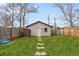 Backyard with grass, stepping stone pathway, and detached garage at 3123 N Elizabeth St, Denver, CO 80205