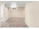 Spacious basement area with neutral carpet and walls, providing ample living space at 3123 N Elizabeth St, Denver, CO 80205