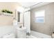 Bright bathroom with white fixtures, modern tile, and a shower-tub combination at 3123 N Elizabeth St, Denver, CO 80205