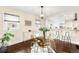 Bright dining room with modern light fixture, glass-top table, view to kitchen at 3123 N Elizabeth St, Denver, CO 80205