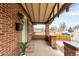 Inviting front porch with exposed rafters and brick pillars, perfect for relaxing at 3123 N Elizabeth St, Denver, CO 80205