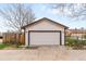 Detached garage with white door and access to the backyard through a wooden fence at 3123 N Elizabeth St, Denver, CO 80205