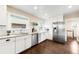 Updated kitchen features stainless steel appliances, white cabinets, subway tile, and hardwood flooring at 3123 N Elizabeth St, Denver, CO 80205