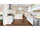 Bright kitchen featuring stainless steel appliances, white cabinets, and a subway tile backsplash at 3123 N Elizabeth St, Denver, CO 80205