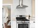 Modern kitchen features stainless steel stove, hood, and white subway tile backsplash at 3123 N Elizabeth St, Denver, CO 80205