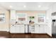 Bright kitchen with white cabinetry, stainless steel appliances, and subway tile backsplash at 3123 N Elizabeth St, Denver, CO 80205