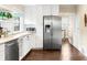 Bright kitchen featuring stainless steel appliances, white cabinets and subway tile at 3123 N Elizabeth St, Denver, CO 80205