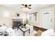 Comfortable living room with fireplace, hardwood floors, and natural light, door leading to front at 3123 N Elizabeth St, Denver, CO 80205