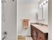 Bathroom featuring a shower and a wood vanity with a sink, mirror, and a towel rack at 7933 Chase Cir # 182, Arvada, CO 80003