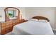 Bedroom with wood furnishings including a bed, dresser, and mirror, along with a window to let in natural light at 7933 Chase Cir # 182, Arvada, CO 80003