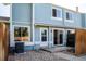 Charming blue two-story home with a cozy patio area and well-maintained landscaping at 7933 Chase Cir # 182, Arvada, CO 80003