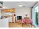 Cozy kitchen with white appliances, a dining table, and sliding glass door to the backyard at 7933 Chase Cir # 182, Arvada, CO 80003