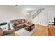 Comfortable living room with plush seating, hardwood floors, and staircase access at 7933 Chase Cir # 182, Arvada, CO 80003
