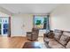Open living room layout with hardwood floors, a comfortable sofa, and access to the backyard at 7933 Chase Cir # 182, Arvada, CO 80003