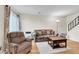 Cozy living room features a comfortable sofa, recliner, and plenty of natural light at 7933 Chase Cir # 182, Arvada, CO 80003