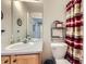 Well lit bathroom with a large mirror, patterned shower curtain, and light wood cabinet at 1230 E 130Th Ave # D, Thornton, CO 80241