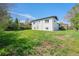 Spacious backyard with a well-maintained lawn and mature landscaping, providing privacy at 1580 S Krameria St, Denver, CO 80224