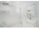 Bright bathroom with a modern shower and vanity featuring clean, white marble at 1580 S Krameria St, Denver, CO 80224