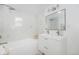 Bright, renovated bathroom featuring marble walls and modern fixtures at 1580 S Krameria St, Denver, CO 80224