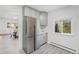 Remodeled kitchen with stainless steel refrigerator, white counters and view into the dining room at 1580 S Krameria St, Denver, CO 80224