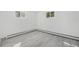Clean room with ample sunlight and grey wood floors at 1580 S Krameria St, Denver, CO 80224