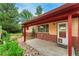 A cozy covered patio area with brick accents and a small garden is perfect for relaxing at 8675 Calvin Dr, Arvada, CO 80002