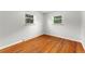 Bright bedroom with hardwood floors and two windows providing natural light at 8675 Calvin Dr, Arvada, CO 80002