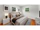 Stylishly furnished bedroom boasts hardwood floors, neutral colors, and ample natural light at 8675 Calvin Dr, Arvada, CO 80002