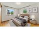 Cozy bedroom offers ample natural light, with large windows and stylish bedside tables at 8675 Calvin Dr, Arvada, CO 80002