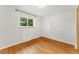 This bedroom is bright with hardwood floors and a large window at 8675 Calvin Dr, Arvada, CO 80002