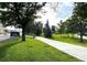 View of the Ralston Central Park showcasing a manicured lawn, sidewalk, and beautiful trees at 8675 Calvin Dr, Arvada, CO 80002