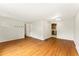 Spacious living room with gleaming hardwood floors and access to the kitchen at 8675 Calvin Dr, Arvada, CO 80002