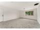 Spacious living room with neutral carpet, perfect for relaxation and entertaining at 8675 Calvin Dr, Arvada, CO 80002