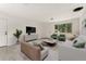 Cozy living room features stylish furniture, a large window, and bright, neutral décor at 8675 Calvin Dr, Arvada, CO 80002