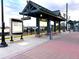Public transit station with seating, posted train schedule, and modern architecture at 8675 Calvin Dr, Arvada, CO 80002