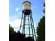 Panoramic view of the Olde Town Arvada water tower against a partly cloudy, blue sky at 8675 Calvin Dr, Arvada, CO 80002