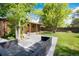 A spacious backyard featuring mature shade trees, a patio, and outdoor furniture perfect for entertaining at 2415 Pontiac St, Denver, CO 80207