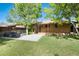Well-maintained backyard with patio and a privacy fence provides a serene outdoor retreat at 2415 Pontiac St, Denver, CO 80207