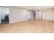Open basement area with wood floors, access to laundry, and stairs to the upper floors at 2415 Pontiac St, Denver, CO 80207