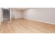 Expansive basement space with modern flooring and adjacent staircase with patterned tile at 2415 Pontiac St, Denver, CO 80207